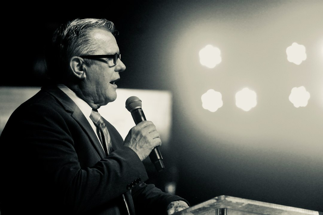 person giving speech on stage