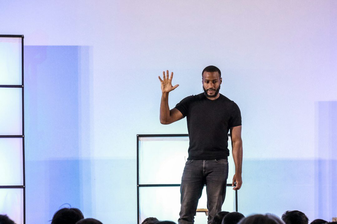 person giving speech on stage